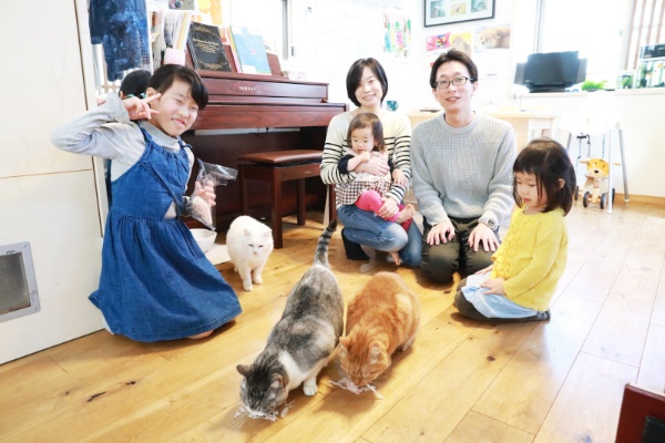 水澤麻里子さんと夫の賢太さん、3人の娘たち。猫は右からどんぐりくん、ほたてちゃん、チロくん