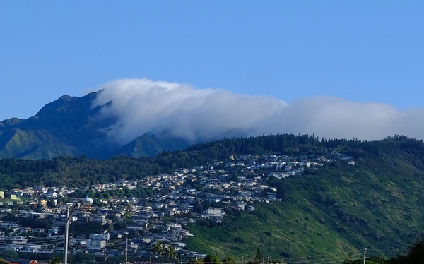 ハワイ・オアフ島で撮った「滝雲」。盆地にたまっていた霧が、山の稜線（りょうせん）を越えると雲の滝のように見えることから呼ばれる「雲海の発展形」。日本にも名所がいくつかあるが、旅先のハワイで初見。豊富な水蒸気＋朝の冷え込み＋霧をせき止める稜線という条件がそろうと見られる